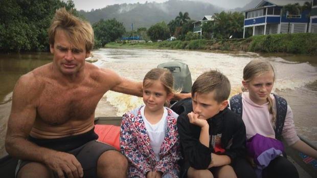 Kauai Big Storm. Pro surfer Laird Hamilton rescuing children stranded by the flooding.